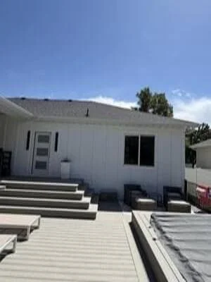 Commercial building with new metal roof and white exterior siding in Ogden